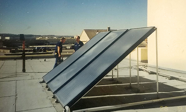 old picture of a solar installation on the roof of building in San Francisco